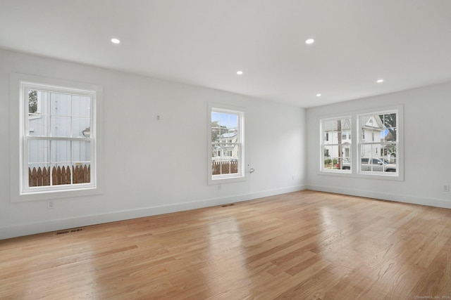 unfurnished living room with light wood-style floors, recessed lighting, visible vents, and baseboards