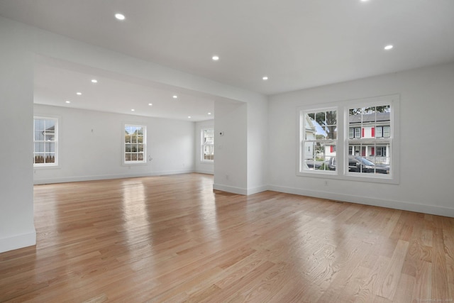 unfurnished living room with light wood-style flooring, baseboards, and recessed lighting