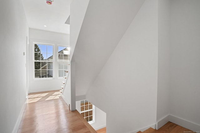 stairs with recessed lighting, baseboards, and wood finished floors