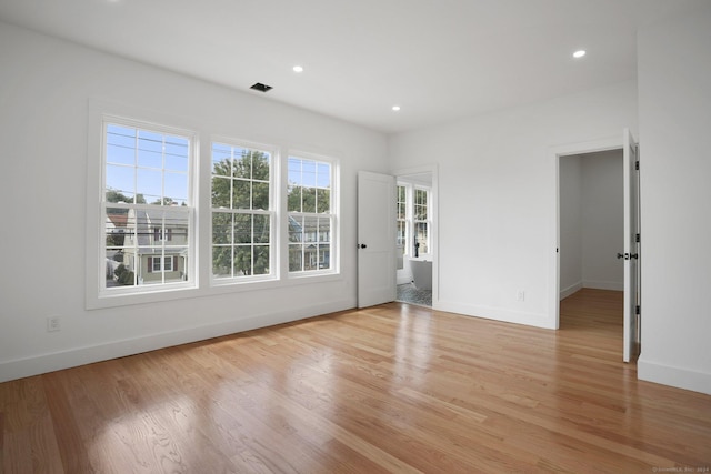 unfurnished room featuring light wood-style floors, baseboards, and recessed lighting