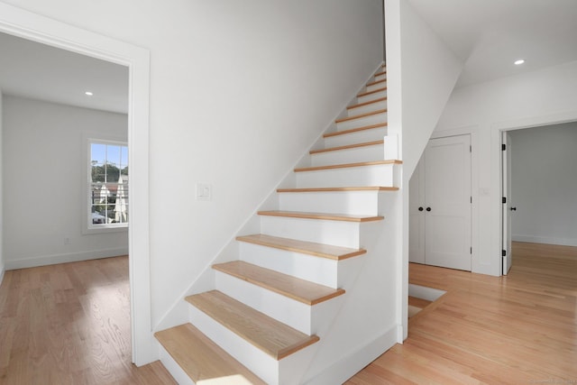 stairway with recessed lighting, baseboards, and wood finished floors