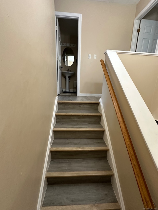 staircase with wood-type flooring