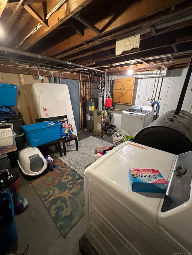 basement with water heater and washing machine and clothes dryer