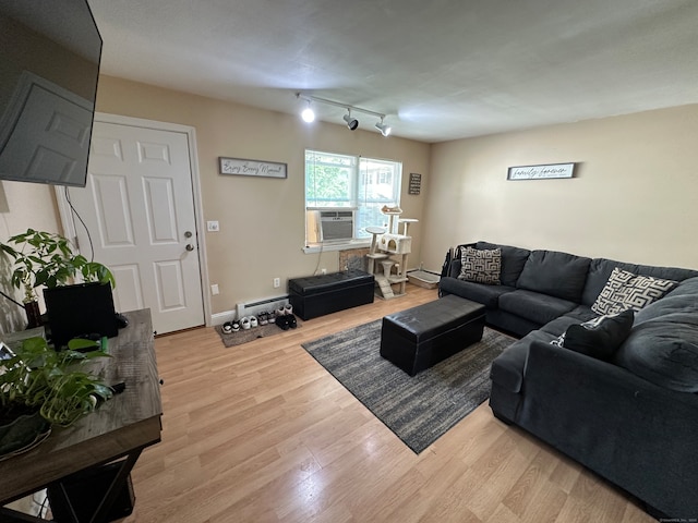 living room with light wood-type flooring, rail lighting, and baseboard heating