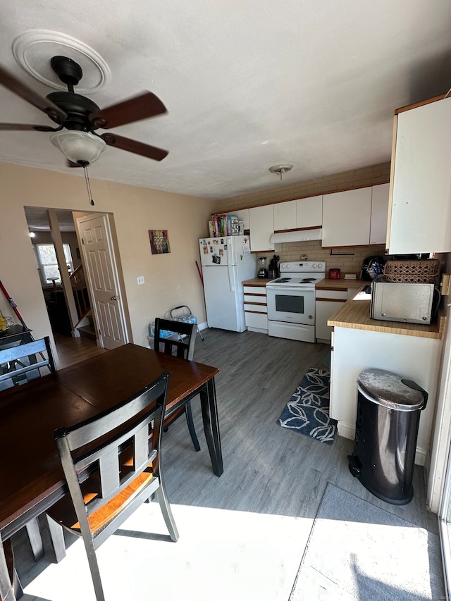 kitchen with ceiling fan, backsplash, white cabinetry, hardwood / wood-style flooring, and white appliances