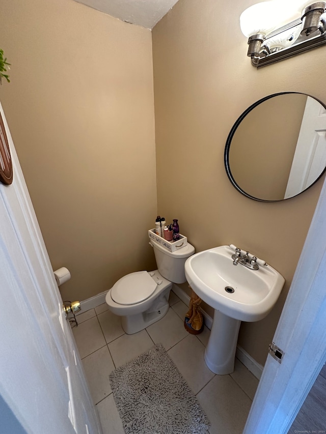 bathroom featuring toilet and tile patterned floors