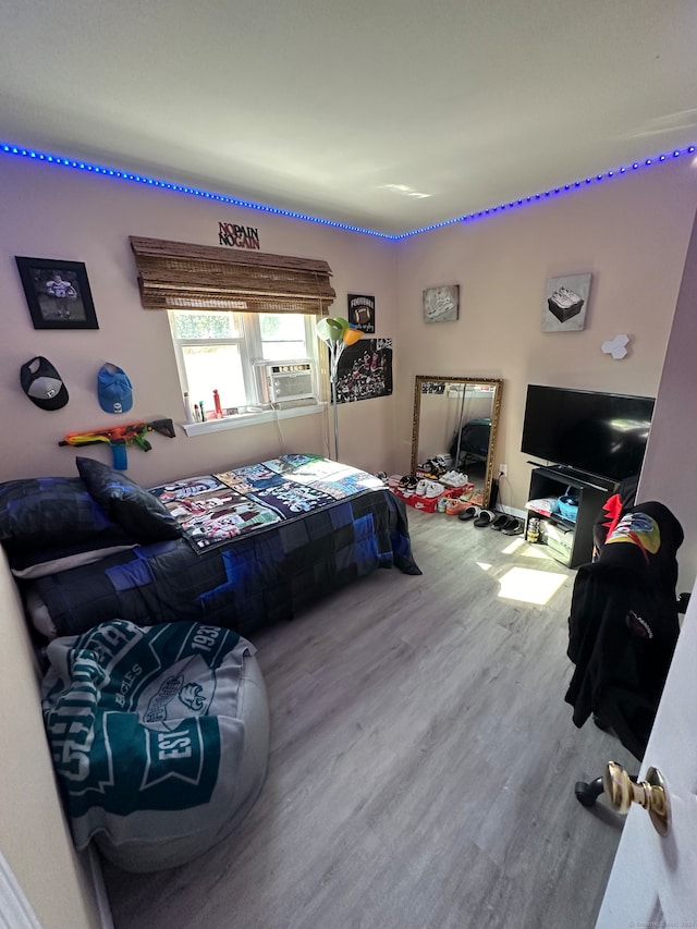 bedroom featuring hardwood / wood-style floors and cooling unit