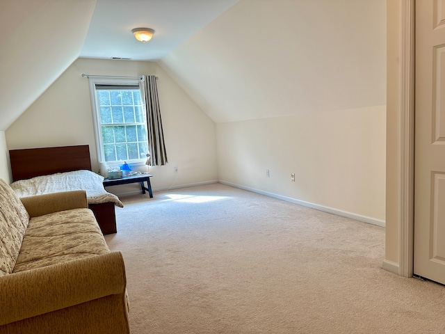 additional living space with light colored carpet and lofted ceiling