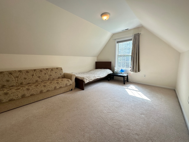 unfurnished bedroom featuring light colored carpet and lofted ceiling