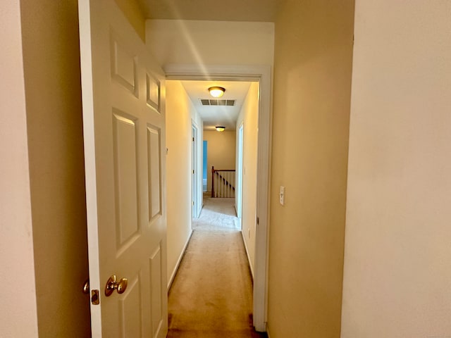 hallway with light colored carpet