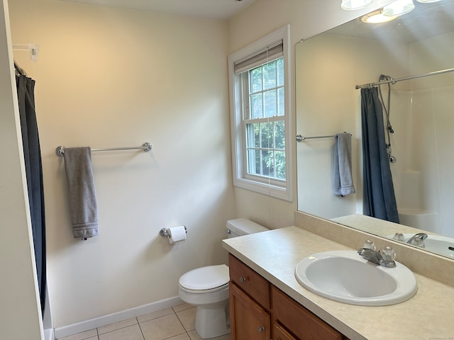 bathroom featuring toilet, vanity, a shower with shower curtain, and tile patterned floors