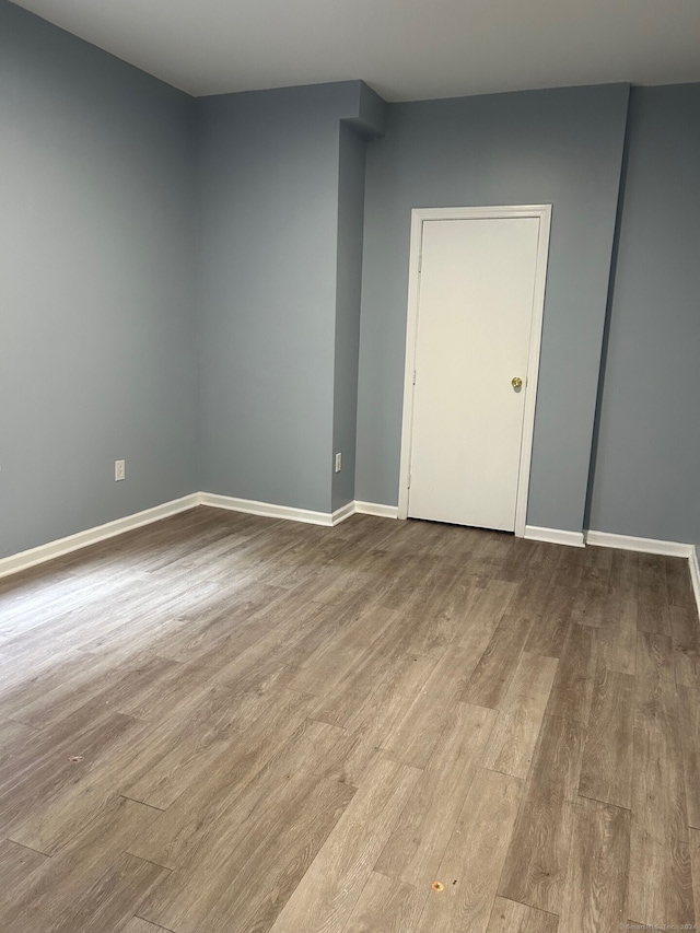 empty room with light hardwood / wood-style flooring