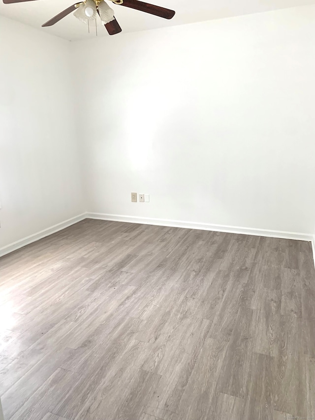 spare room featuring ceiling fan and hardwood / wood-style floors