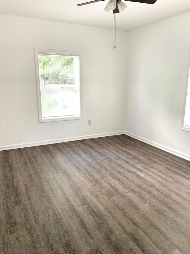 empty room with dark hardwood / wood-style flooring and ceiling fan