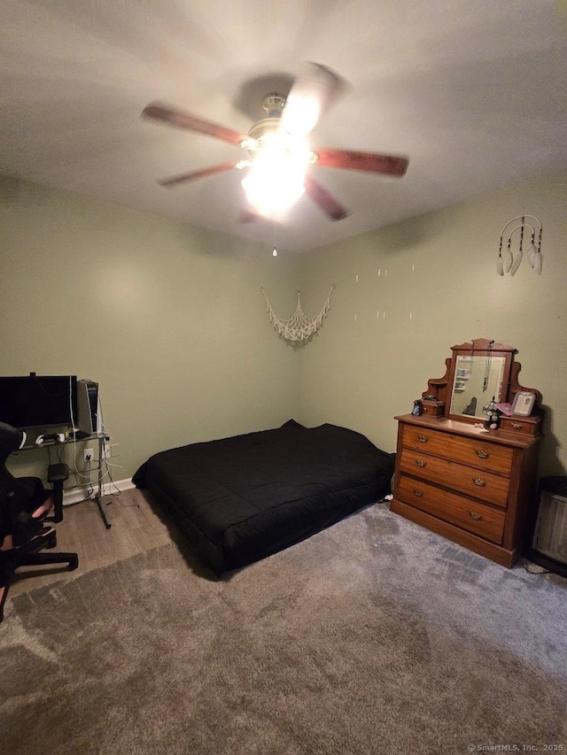 bedroom with ceiling fan and light carpet