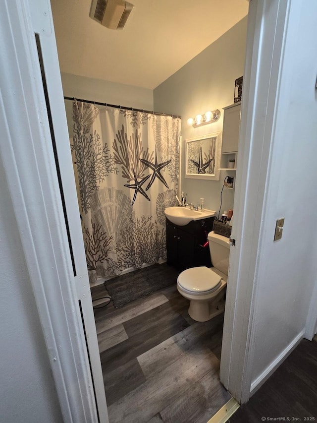 bathroom featuring hardwood / wood-style floors, vanity, toilet, and a shower with curtain