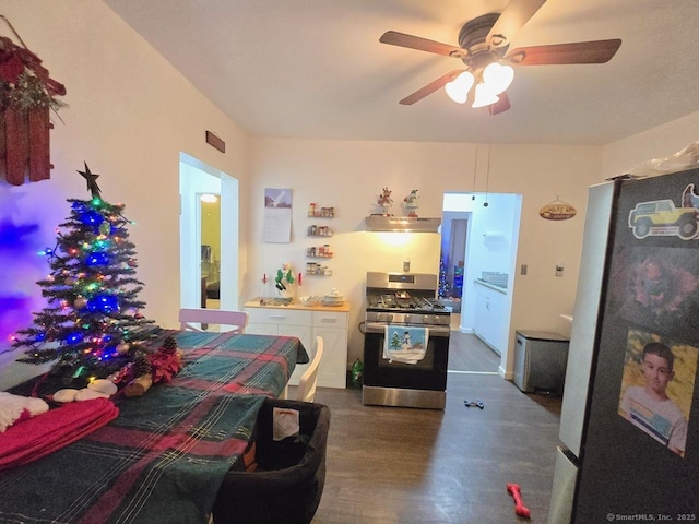 bedroom with stainless steel refrigerator, ceiling fan, and dark wood-type flooring