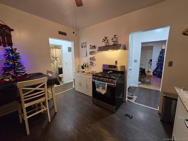 kitchen featuring white cabinets, stainless steel range with gas cooktop, dark wood-type flooring, and extractor fan