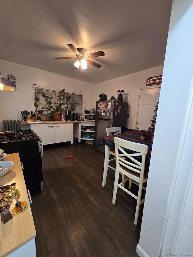 dining room with dark hardwood / wood-style floors and ceiling fan