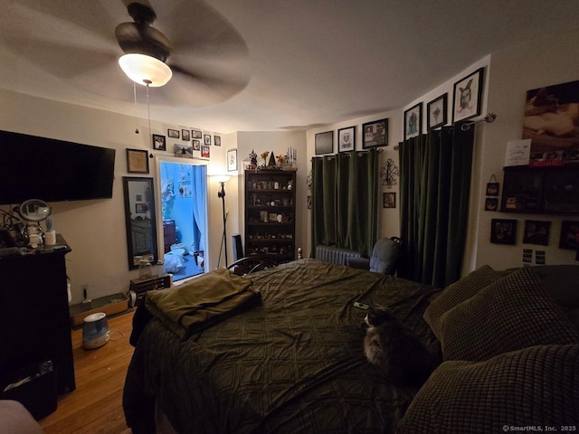 bedroom featuring ceiling fan and hardwood / wood-style floors