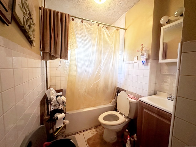 full bathroom with toilet, vanity, tile walls, a textured ceiling, and shower / tub combo with curtain