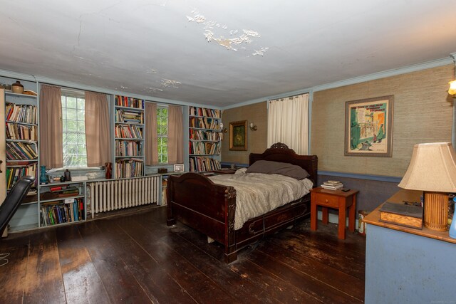 bedroom with crown molding and hardwood / wood-style floors