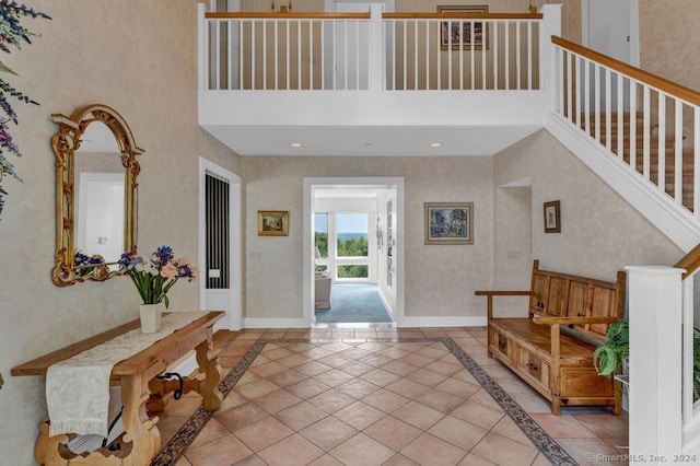138 River Rd, Deep River, CT 06417 - foyer featuring a towering ceiling, inlaid floor details, stairway, and baseboards