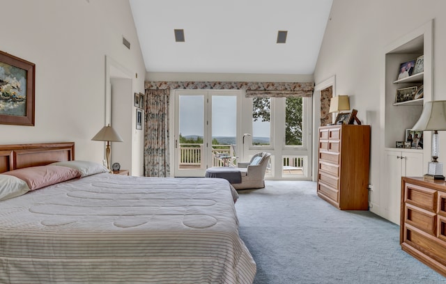 carpeted bedroom with access to outside, french doors, and high vaulted ceiling