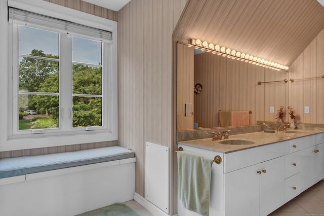 bathroom featuring vanity, tile patterned floors, and vaulted ceiling