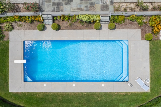 view of pool featuring a diving board