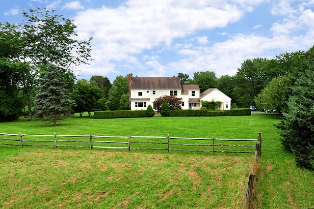 view of yard featuring fence and a rural view