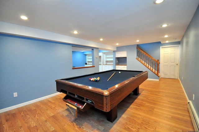 recreation room with light wood-type flooring, a baseboard radiator, and baseboards