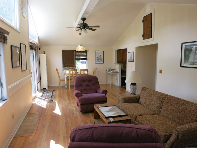 living room featuring ceiling fan, high vaulted ceiling, and light hardwood / wood-style flooring