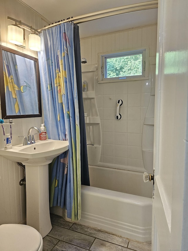 full bathroom featuring sink, wood-type flooring, shower / tub combo, and toilet