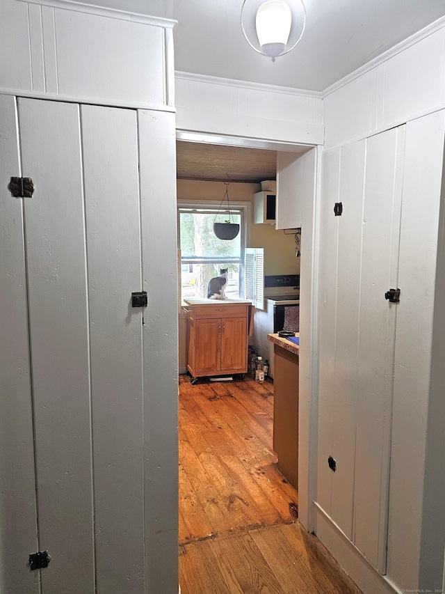 corridor with light hardwood / wood-style floors