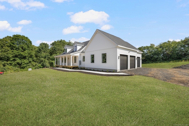 view of home's exterior with a garage, a porch, and a lawn