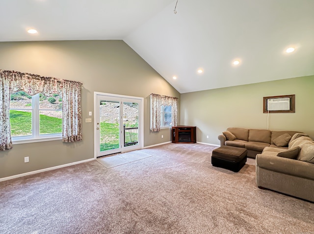 unfurnished living room featuring light colored carpet, high vaulted ceiling, and a wall mounted AC