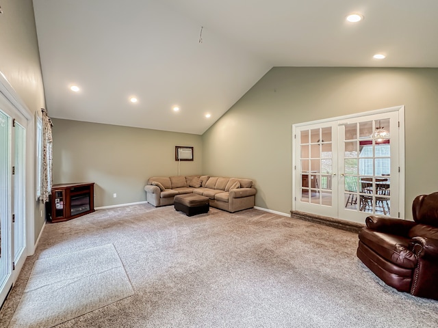 carpeted living room featuring high vaulted ceiling and french doors