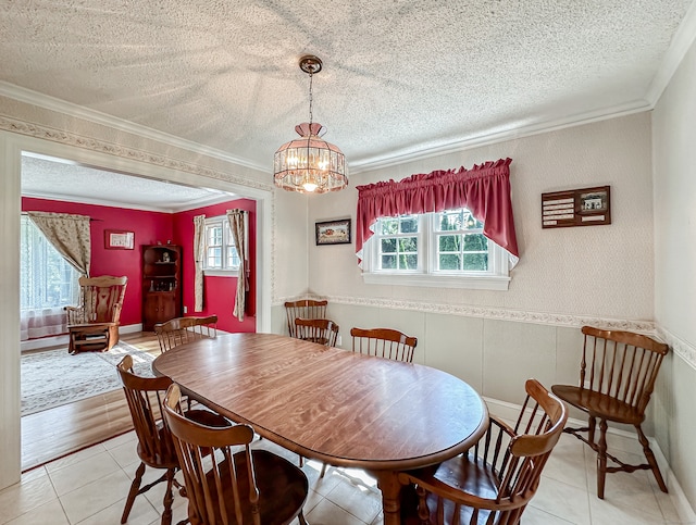 dining area with a textured ceiling and crown molding