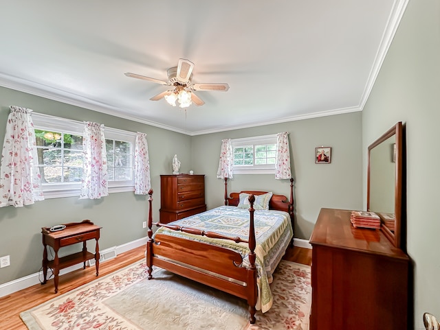 bedroom featuring ceiling fan, ornamental molding, and light wood-type flooring