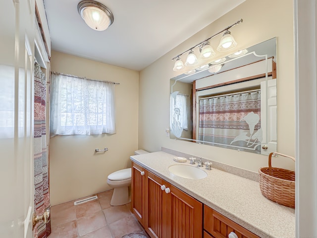 bathroom with curtained shower, tile patterned flooring, toilet, and vanity