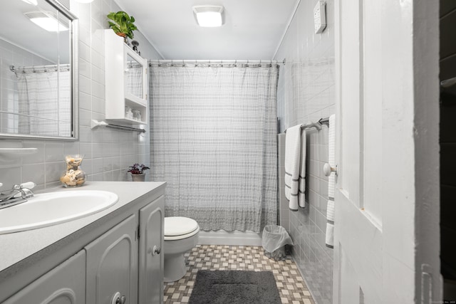 bathroom featuring vanity, toilet, tile walls, and a shower with shower curtain