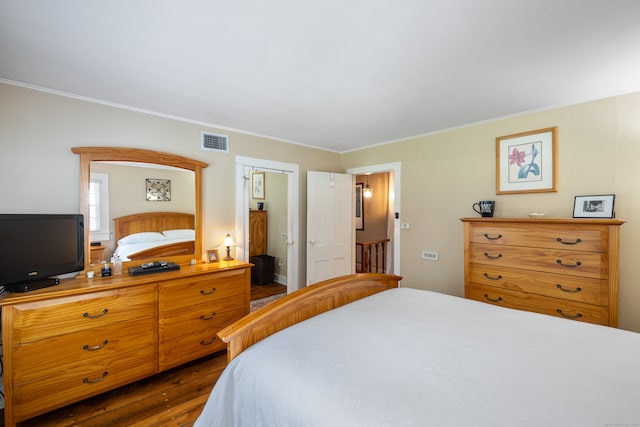 bedroom featuring dark wood-type flooring and ornamental molding