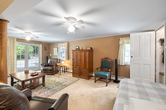 living room featuring a baseboard heating unit, ceiling fan, and light carpet