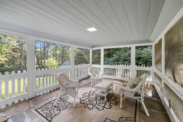 sunroom / solarium featuring wooden ceiling