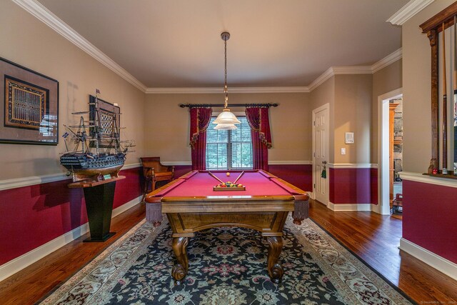 game room with ornamental molding, billiards, and dark hardwood / wood-style flooring