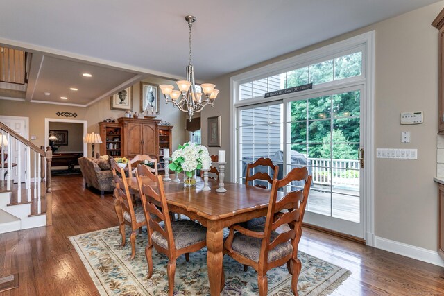 dining room featuring crown molding, a notable chandelier, a wealth of natural light, and dark hardwood / wood-style flooring