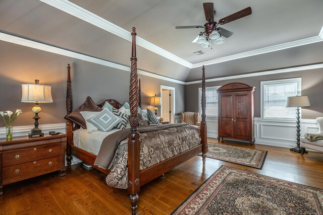 bedroom with dark hardwood / wood-style flooring, ornamental molding, and ceiling fan