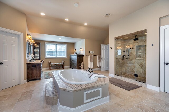 bathroom with vanity and shower with separate bathtub