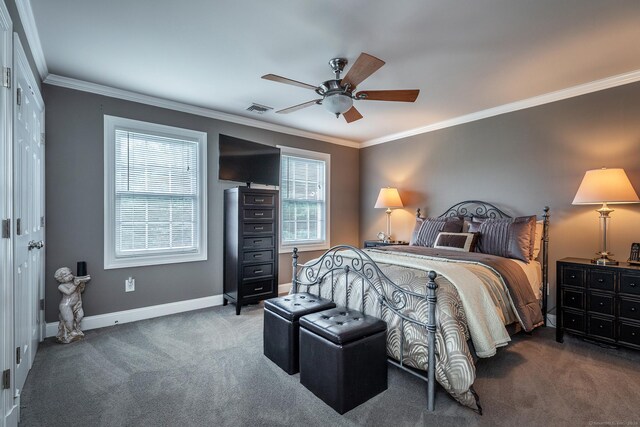 bedroom with dark colored carpet, ornamental molding, and ceiling fan